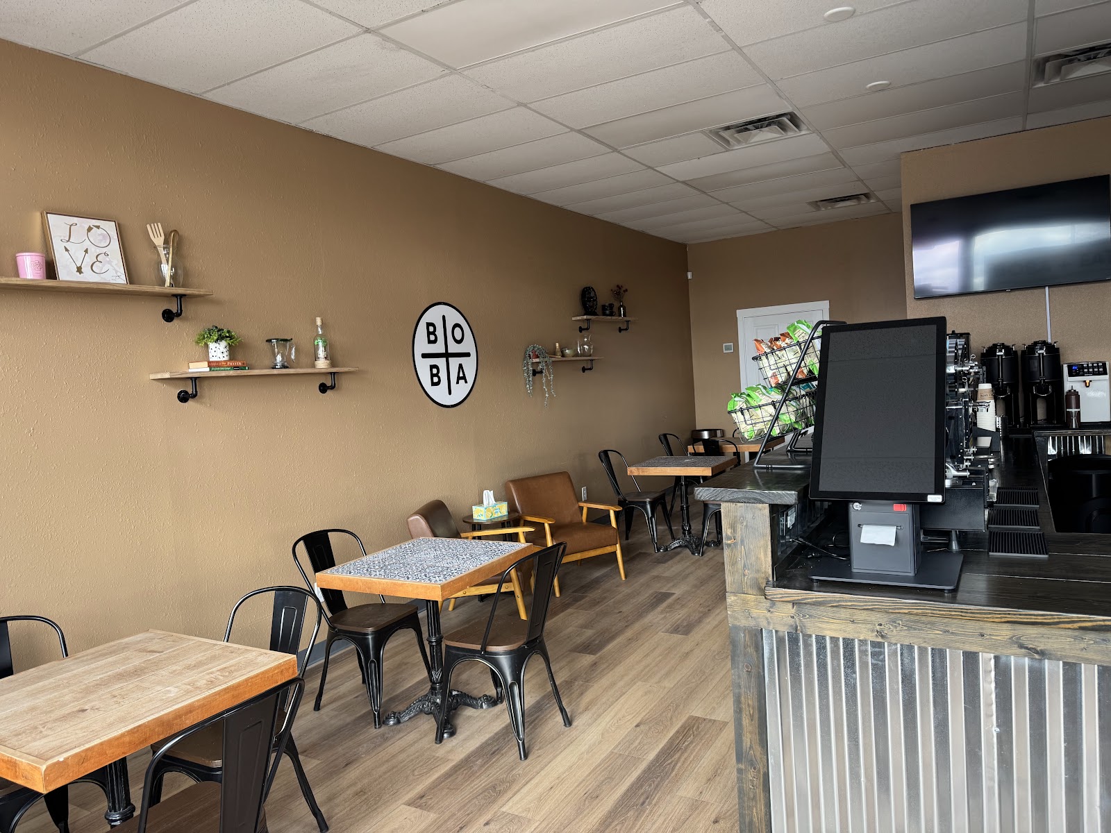 Interior dining area with wood tables at Boba and Eats